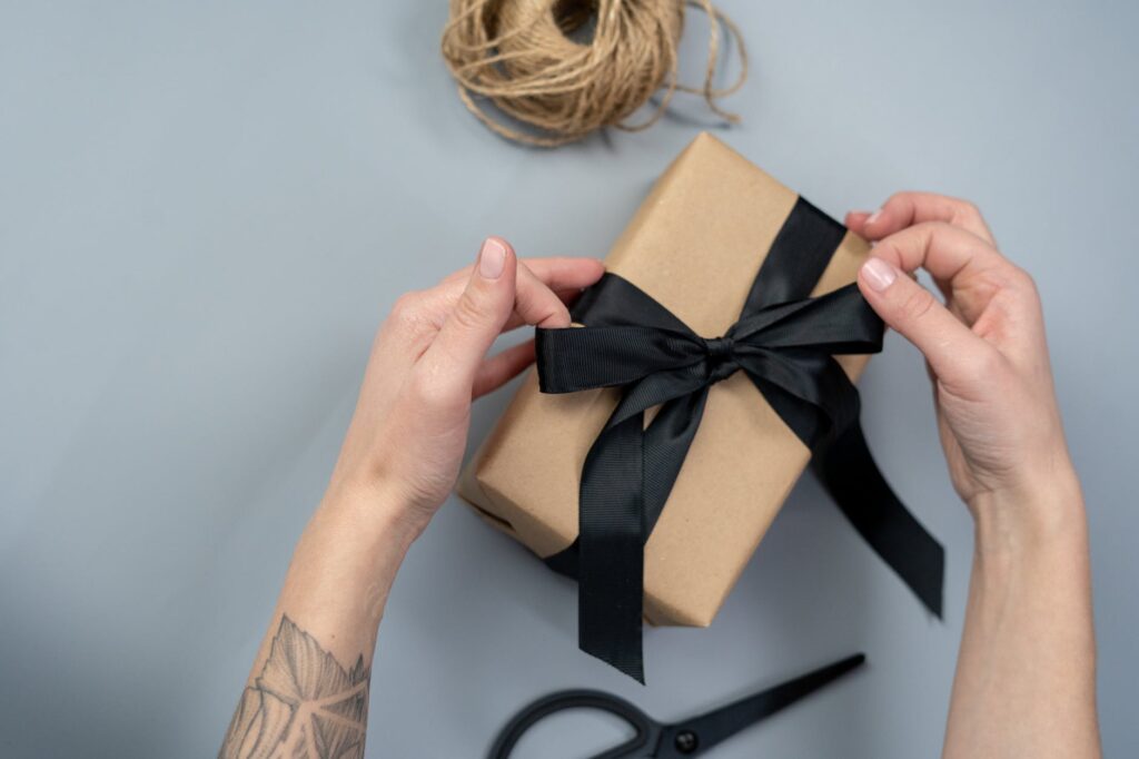 brown gift box with black ribbon