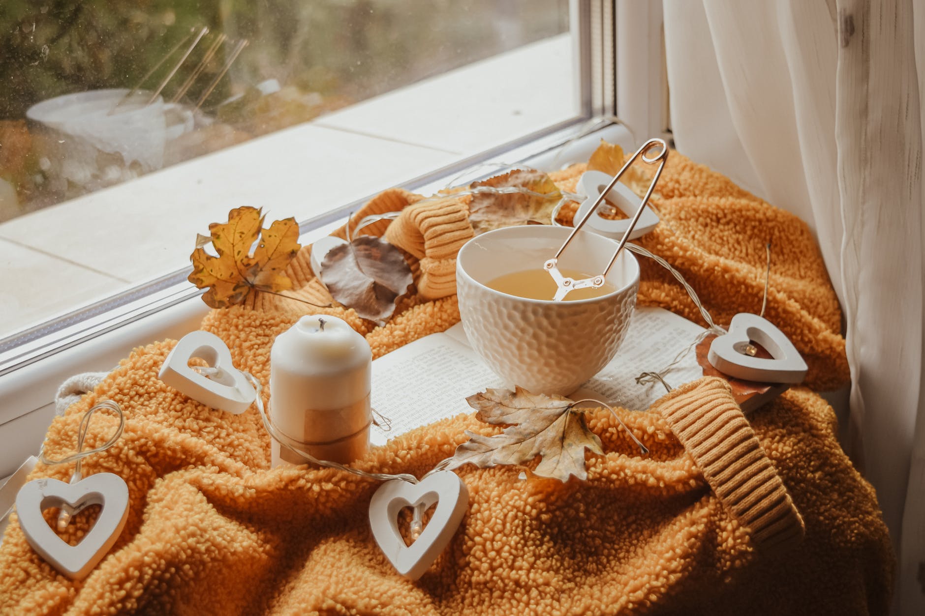 white teacup beside a candle