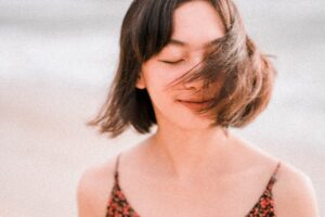 calm ethnic woman waving with short hair